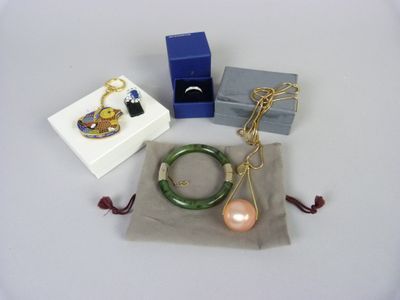 a box with a ring, bracelet, and other items on it