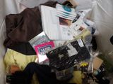 a pile of clothes and other items in a trash can