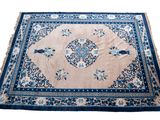 rug with a blue border and a floral design on a white background