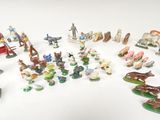 many figurines of different types and sizes on the table