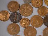 a lot of gold and silver coins on a white surface