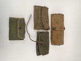 four different types of leather cases are lined up on a white surface