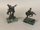 pair of bronze figurines of a man on a horse and a woman on a horse