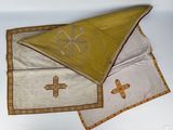 two pieces of cloth with crosses on them on a table