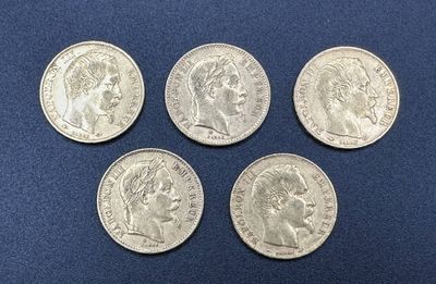 four silver coins of different sizes and shapes on a blue surface