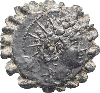 a close up of a coin with a face on it