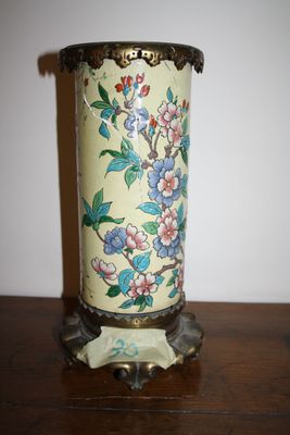 a vase that has flowers on it on a table