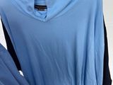 a blue shirt on a mannequin with a black shirt underneath it