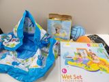 a baby ' s wet set on a table next to a book and toy