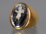 a close up of a gold ring with an image of a man and a woman