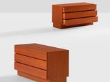 three pieces of wood are stacked on top of each other on a white surface