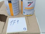 two cans of paint sitting on top of a cardboard box