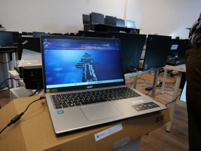 a laptop computer sitting on top of a table in a room