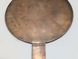 a large metal mirror hanging on the wall