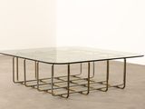 an image of a glass and brass coffee table with a square glass top