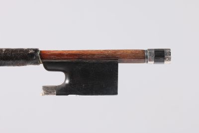 an old violin bow with a wooden handle on a white background