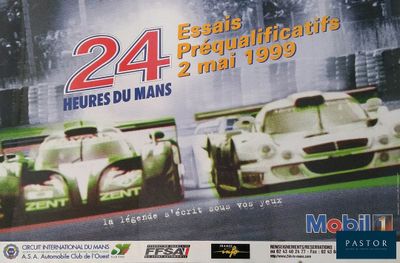 a poster of two racing cars on display in front of a building