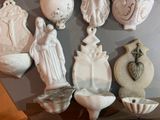 a lot of ceramic figurines that are on a shelf