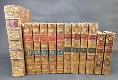 a group of old books sitting on top of each other on a table