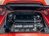 a small engine in the trunk of a red sports car