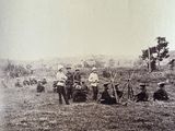 a group of men that are standing in the grass
