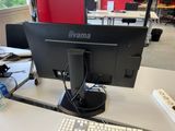 an image of a computer monitor and keyboard on a desk