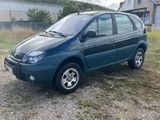 a picture of a small blue car parked in a field