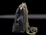 a close up of a black purse with a chain around it