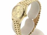 yellow gold rolex watch on display on white display stand