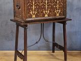 an old wooden chest sitting on top of a wooden table