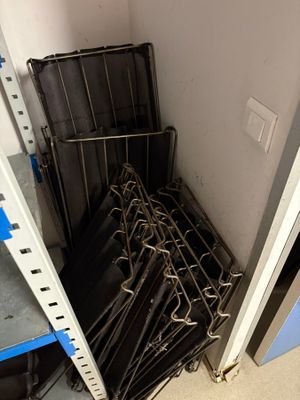 a lot of umbrellas that are hanging in a rack