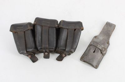 five magazines and a knife on a white surface