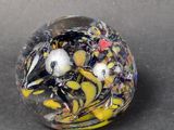 a glass ball with a bird inside of it on a table