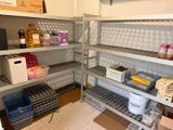 a room with a lot of shelves and bins in it