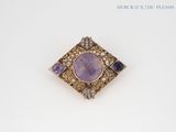 an amethorate and diamond broochle set in 18k gold