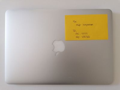 a sticker on the back of an apple laptop