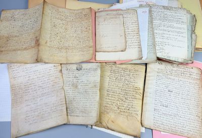 several old books are stacked on top of each other on a table