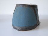 a small blue vase sitting on a white table
