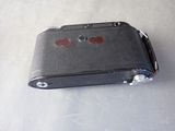 a black case with red buttons on it on a table