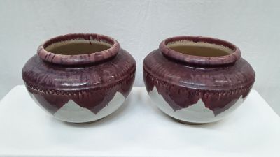 two vases that are sitting on a white table