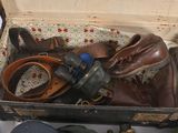 a suitcase full of shoes and other items sitting on a table