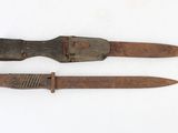 two old knives that are on a white surface