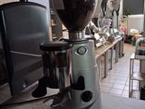a coffee grinder sitting on a counter in a kitchen