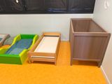two beds and a dresser in the corner of a room