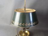 lamp with a green shade and a gold base with a leaf design