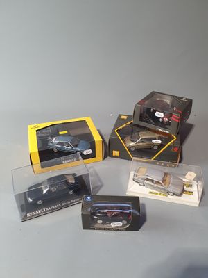 four different models of cars in boxes on a table
