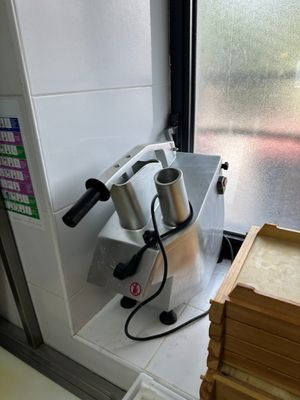 a machine that is sitting on a counter next to a stack of books