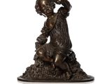 bronze statue of a boy with a bird on his shoulder