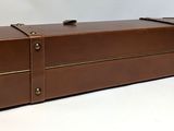 a brown suitcase sitting on top of a white table