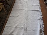 a white rug on the floor next to a table